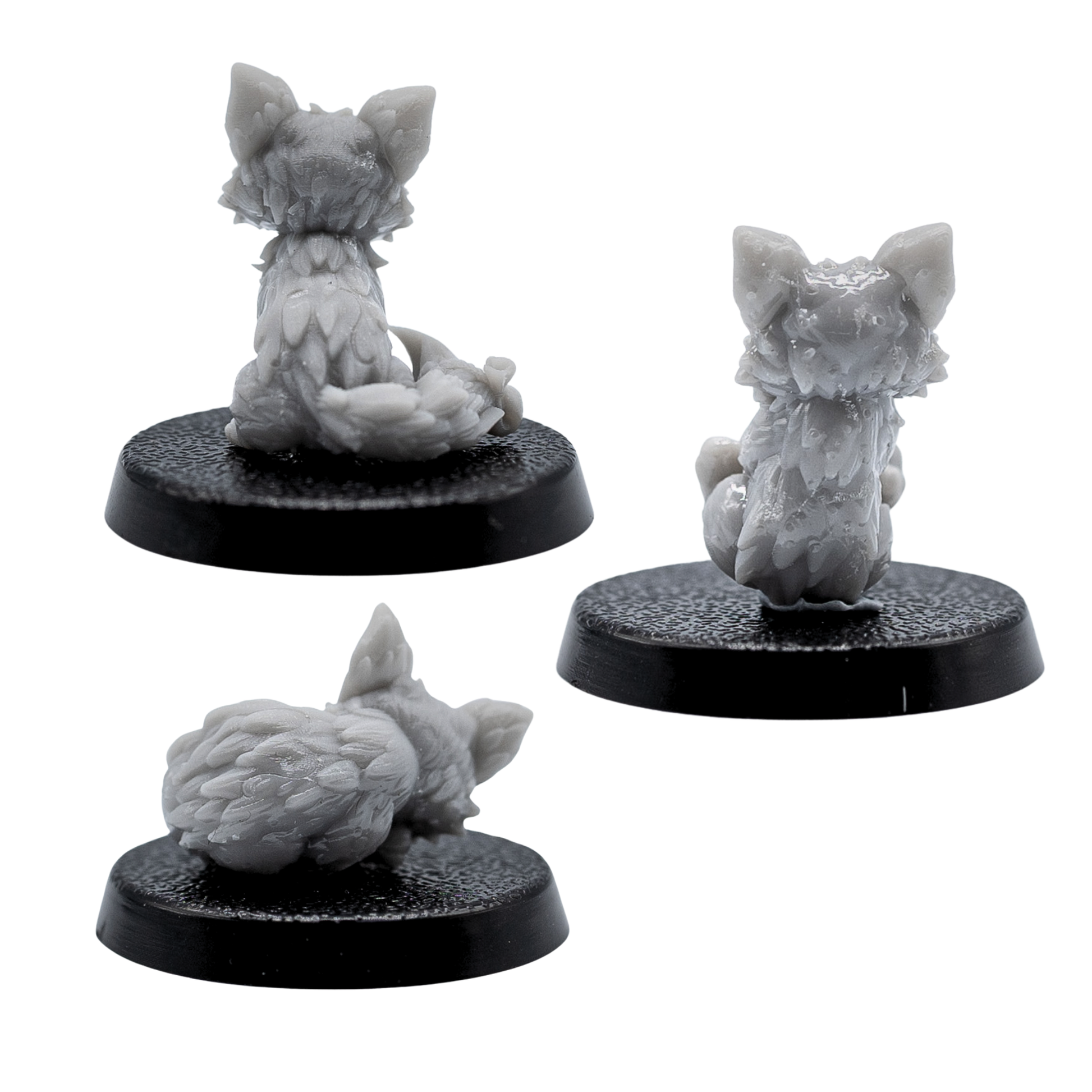 Rear views of the unpainted Fox Familiars miniatures showing detailed tails and fur texture.
