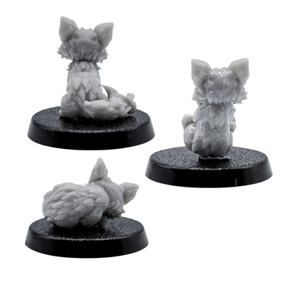 Rear views of the unpainted Fox Familiars miniatures showing detailed tails and fur texture.