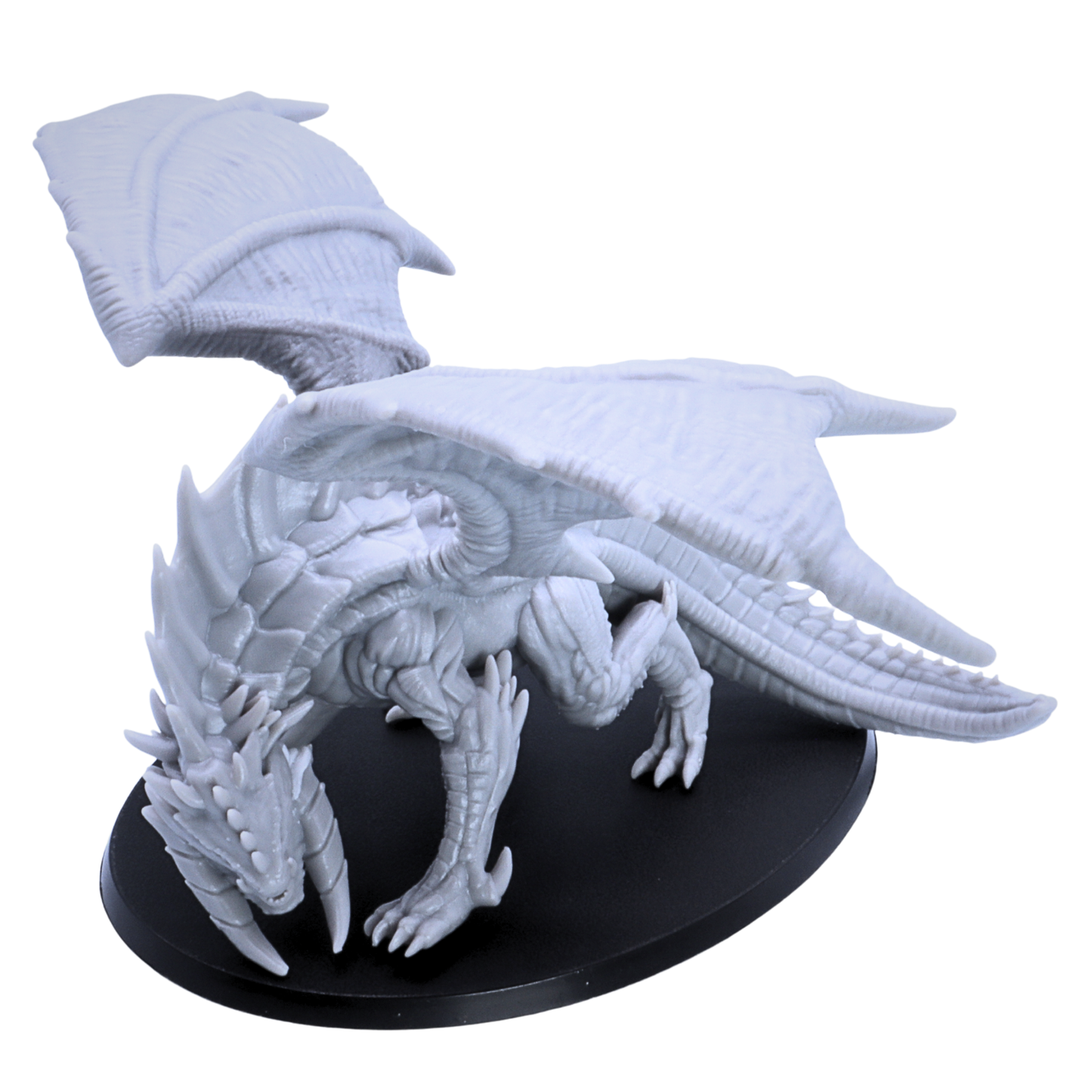 Close side view of unpainted Giant Red Dragon miniature showing scales, claws, horns, wings, and long tail.