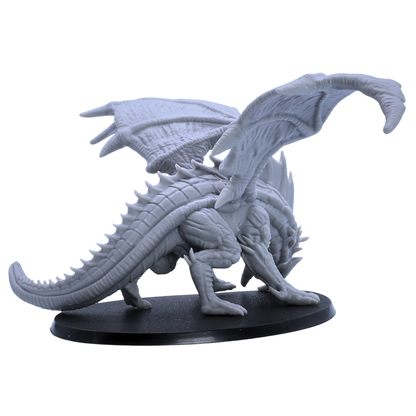 Overhead view of unpainted Giant Red Dragon miniature showing wide wingspan and large oval base.