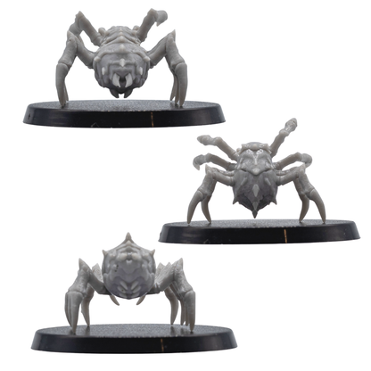 Back angle views of unpainted Giant Spider resin miniatures showing rear body detail, spiked armour plates, long legs, and round bases.