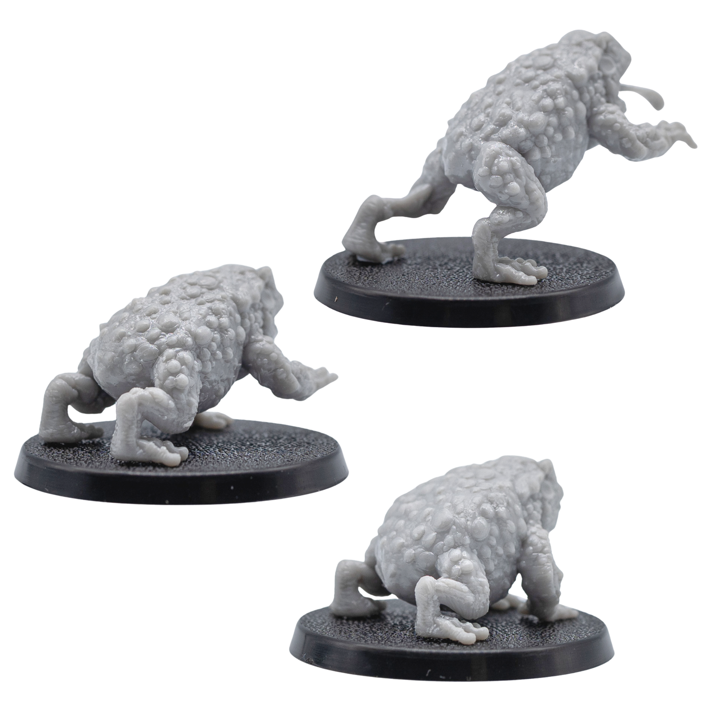 Rear views of the unpainted Giant Toads showing detailed bumpy skin and sculpted limbs in grey resin.