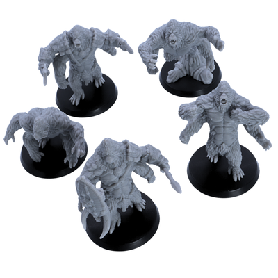 Top angle view of unpainted Girallon miniatures showing the four-armed ape monster designs and round bases.