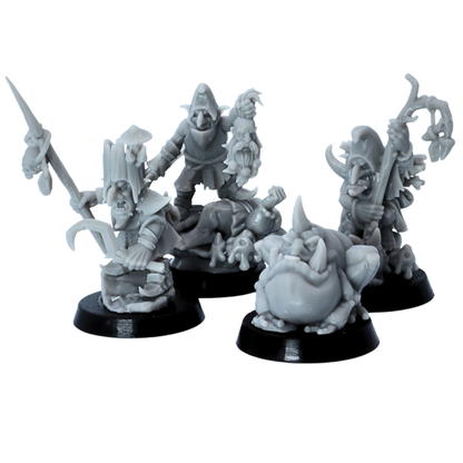 Close view of unpainted goblin character miniatures with weapons, staff, cauldron, and trophy details.