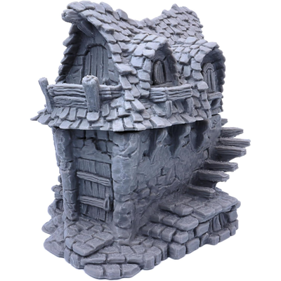 Side view of the fantasy cottage showing the raised timber balcony and stonework.