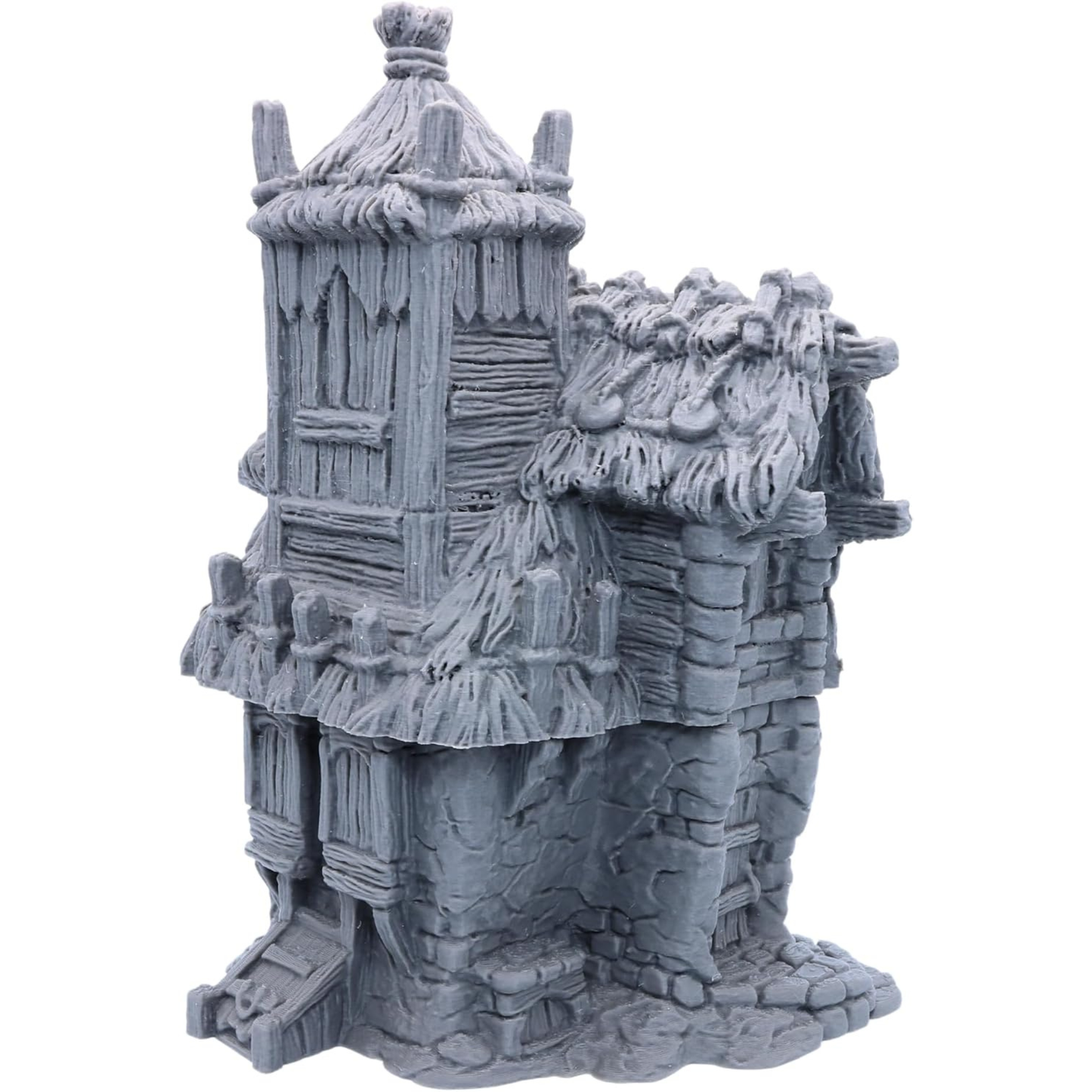 Side view of the Homestead showing its tall timber tower and layered thatched roof.