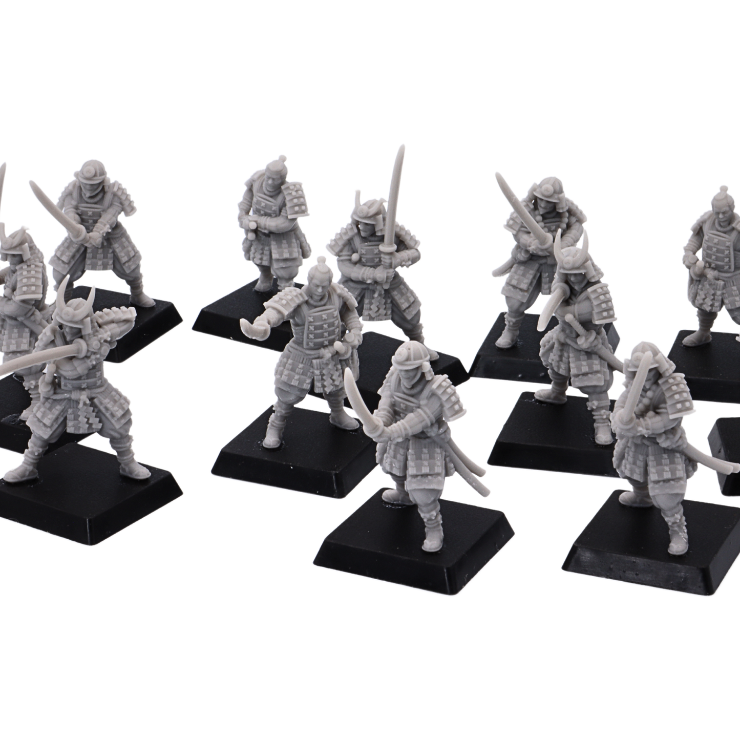 Close-up of unpainted Japanese Samurai Swordsmen miniatures showing armor, helmets, swords, and dynamic warrior poses.