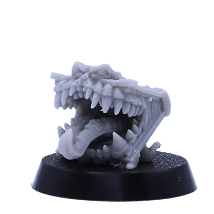 Fantasy chest Mimic miniature with a large tooth-filled mouth and extended tongue.