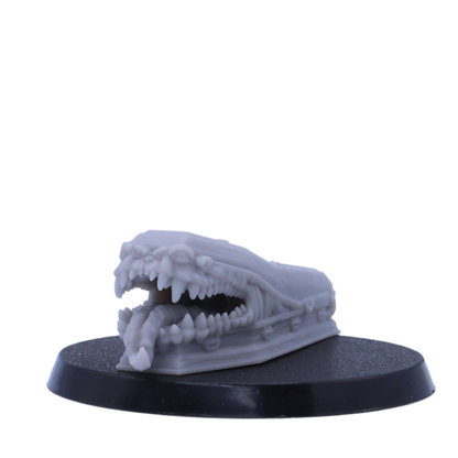 Coffin Mimic miniature with an open monstrous mouth and tongue.