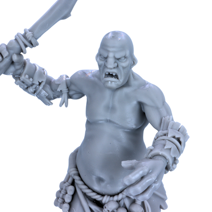 Close-up of unpainted Mountain Giant resin miniature showing angry face, scarred torso, wrist bindings, and large hand detail.
