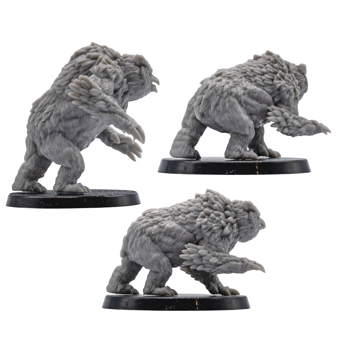 Rear and side views of unpainted Owlbear resin miniatures showing detailed sculpting for tabletop RPG and wargaming use.