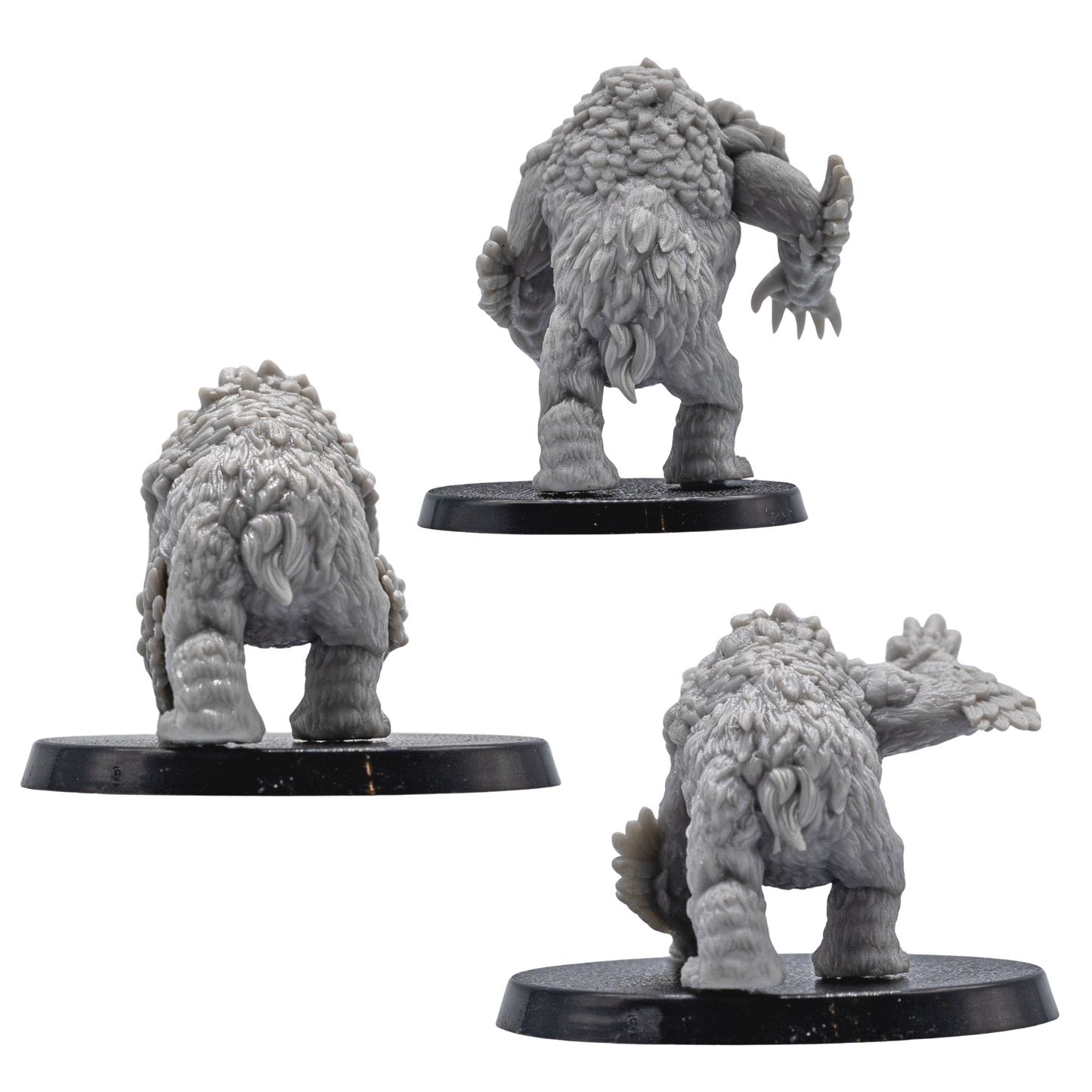 Rear views of unpainted Owlbear resin miniatures showing fur, feather texture, and creature sculpt detail.
