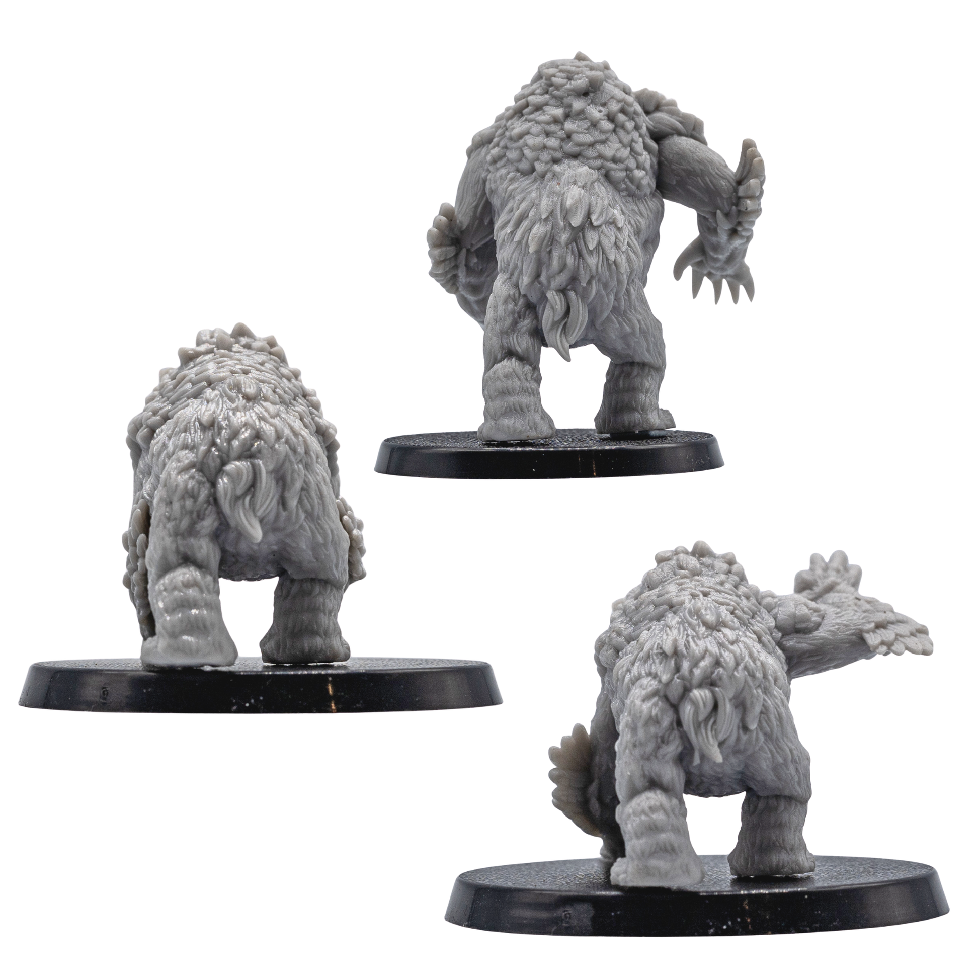 Rear views of unpainted Owlbear resin miniatures showing fur, feather texture, and creature sculpt detail.
