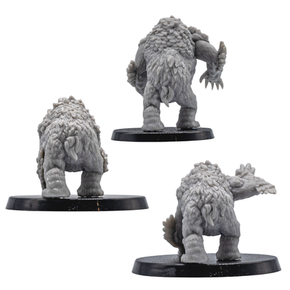 Rear views of unpainted Owlbear resin miniatures showing fur, feather texture, and creature sculpt detail.