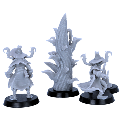 Rear views of unpainted Pumpkin Scarecrows miniatures showing cloaks, hats, roots, branches, and sculpted details.