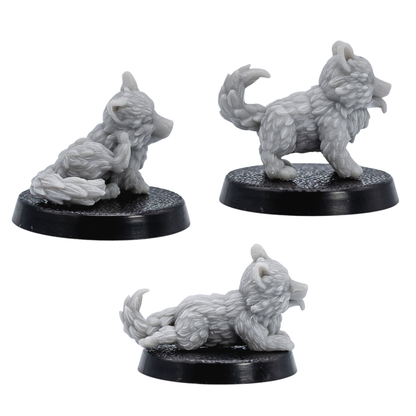 Profile views of unpainted Puppy Familiars showing the lying, standing, and seated puppy sculpts on 25mm round bases.
