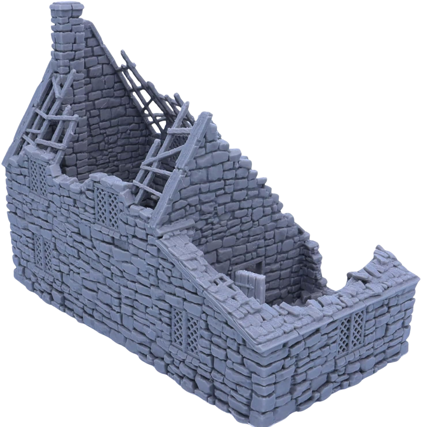 Side and rear angle of the ruined stone cottage showing collapsed masonry, broken roof sections, windows, and open interior.
