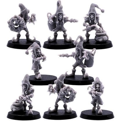 eight unpainted Santa Goblin miniatures in varied festive poses on round bases.
