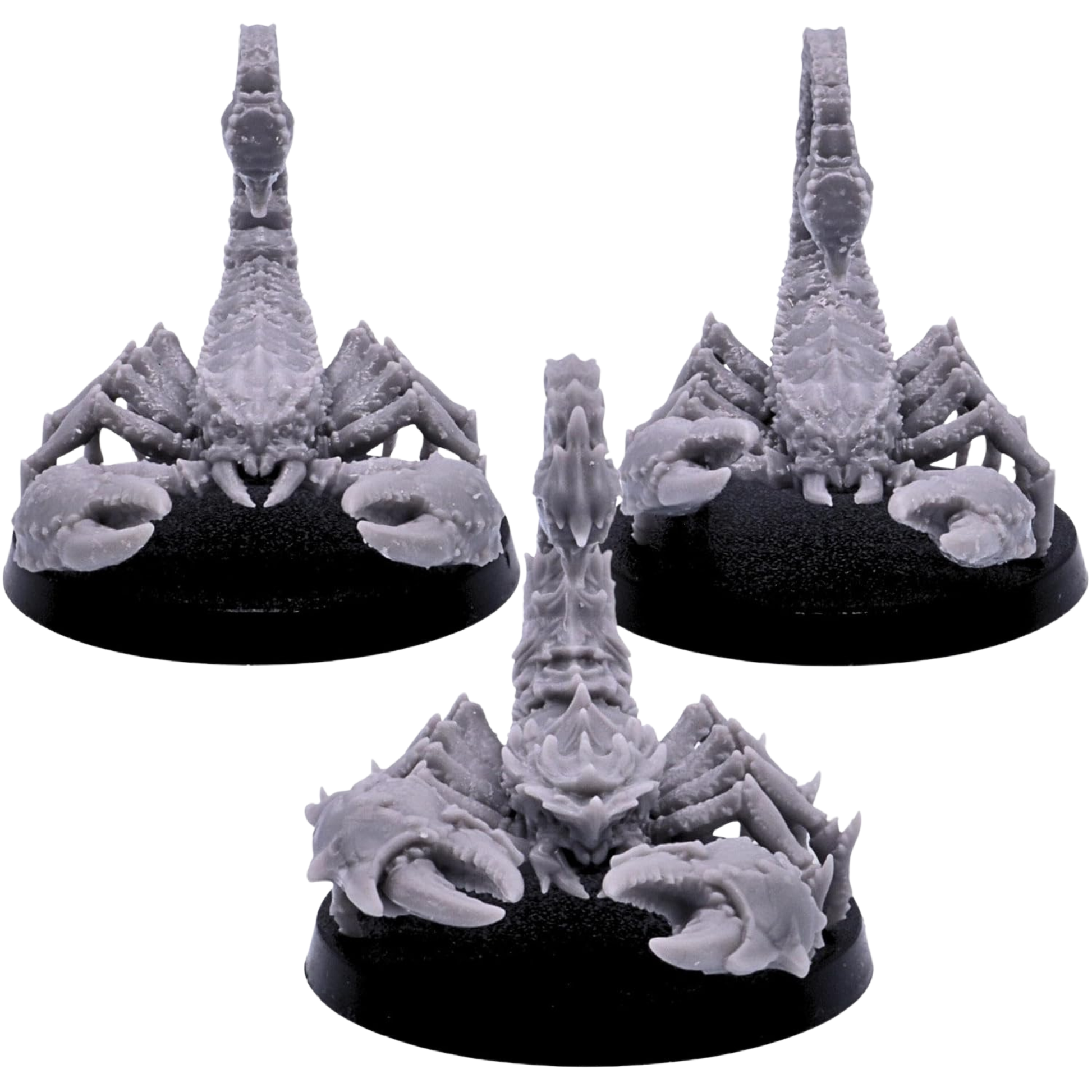 Front views of three unpainted Scorpion miniatures showing massive pincers, plated heads, segmented bodies, and upright stinging tails.
