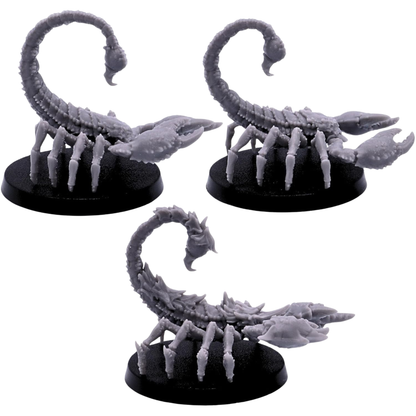 Unpainted Scorpion miniatures shown from alternate side angles with detailed pincers, carapace textures, segmented tails, and raised venomous stingers.
