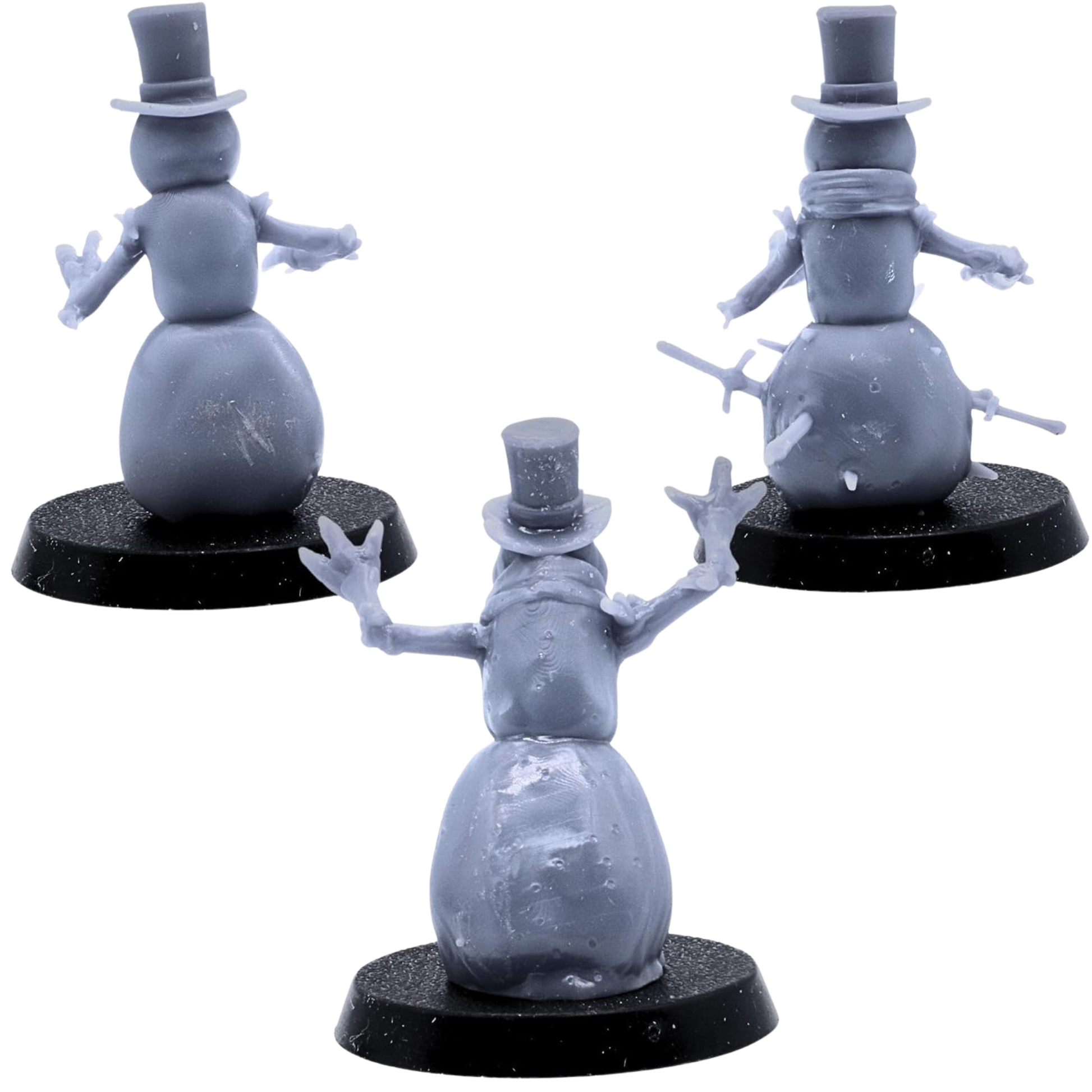 Rear views of the three unpainted Snowmen miniatures showing top hats, branch arms, scarves, snow bodies, and embedded weapons.