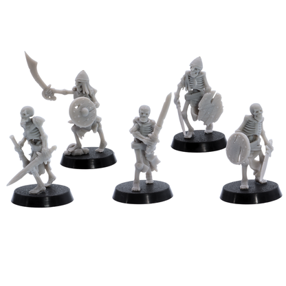 Unpainted Undead Skeletal Warriors showing five fantasy skeleton fighters with blades, shields, helmets, and damaged equipment.