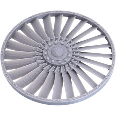 Close-up of the removable-style turbine fan component showing radial blades, central hub, and riveted circular frame.