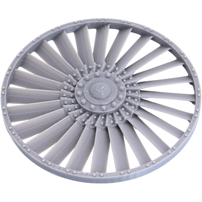 Close-up of the removable-style turbine fan component showing radial blades, central hub, and riveted circular frame.