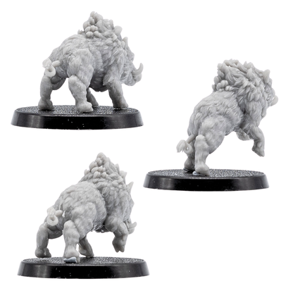 Rear views of unpainted Wild Boar miniatures showing detailed fur, raised manes, tails, muscular legs, and round bases.