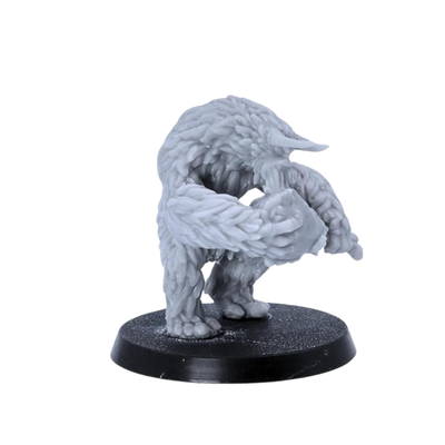 Unpainted Yeti miniature shown from the side with hunched posture, long arms, and thick sculpted fur.