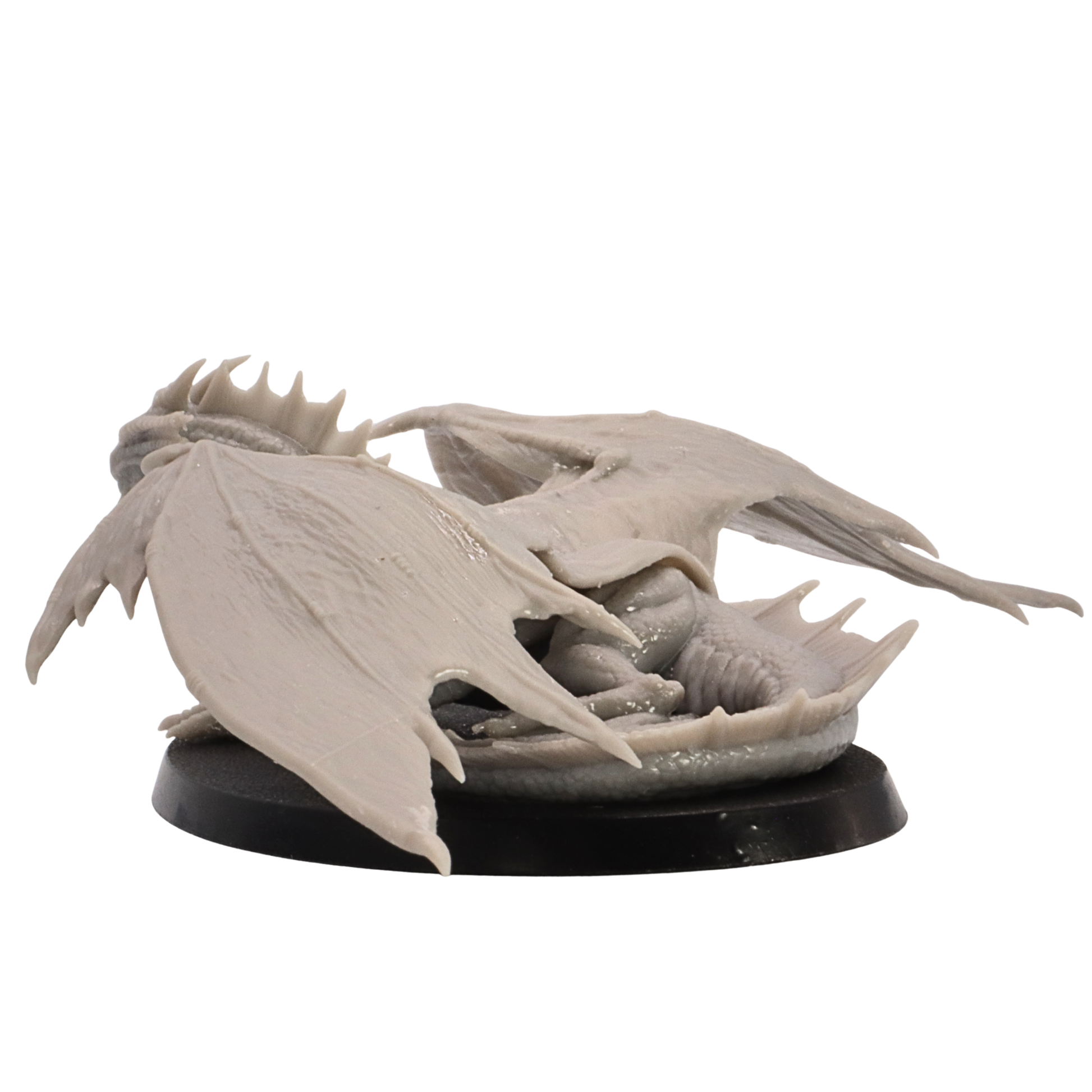 Low side view of the Young Bronze Dragon miniature showing the long wings, crouched pose, and tail.