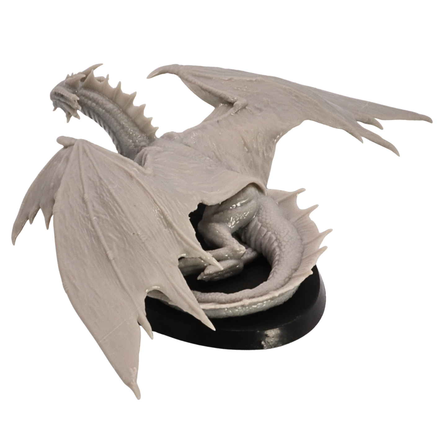 Rear angled view of the Young Bronze Dragon miniature showing folded tail, wings, and oval base.