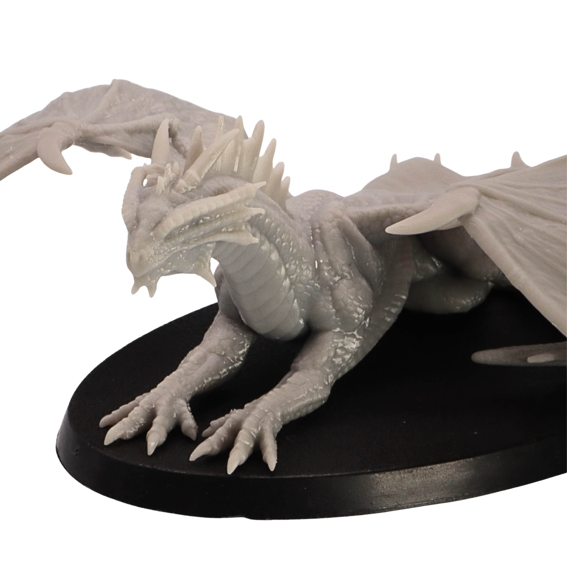 Close side detail of the Young Bronze Dragon miniature showing head, horns, claws, wings, and scale texture.