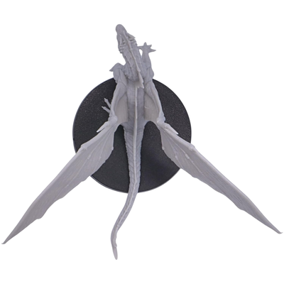 Top view of the unpainted Young Green Dragon miniature showing its long tail, body, large outstretched wings, and 50mm round base.