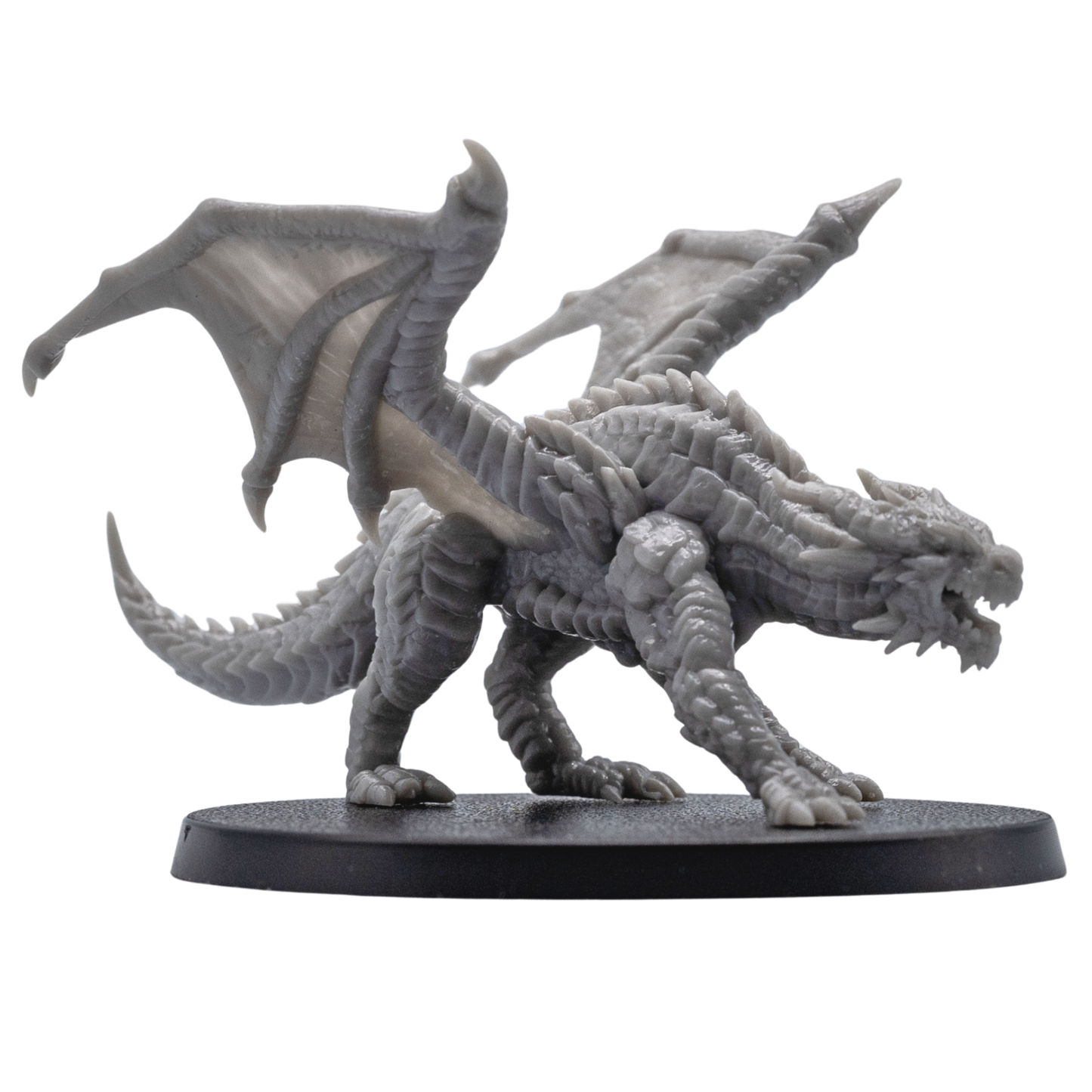 Side view of an unpainted Young Red Dragon resin miniature by Forged Path Miniatures showing wings, scales, horns, and long tail.