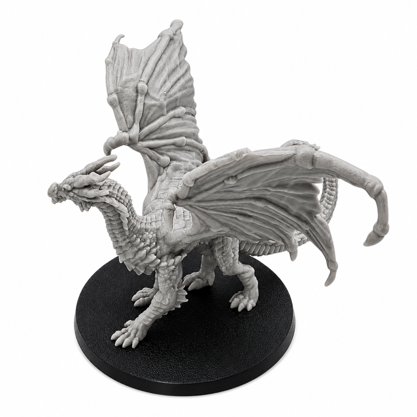 High angle view of an unpainted Young Yellow Dragon miniature showing wing membranes, horns, scales, and 60mm round base.